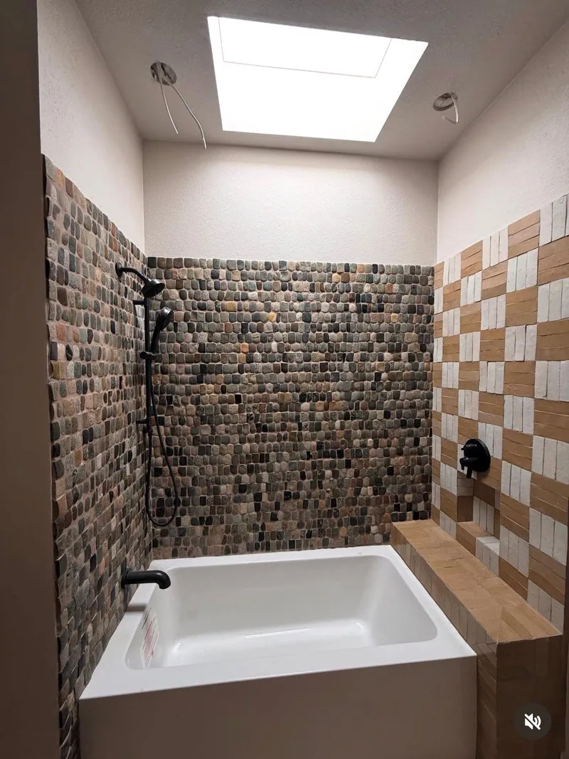 Primary-bath remodel with a freestanding tub and tiled accent wall