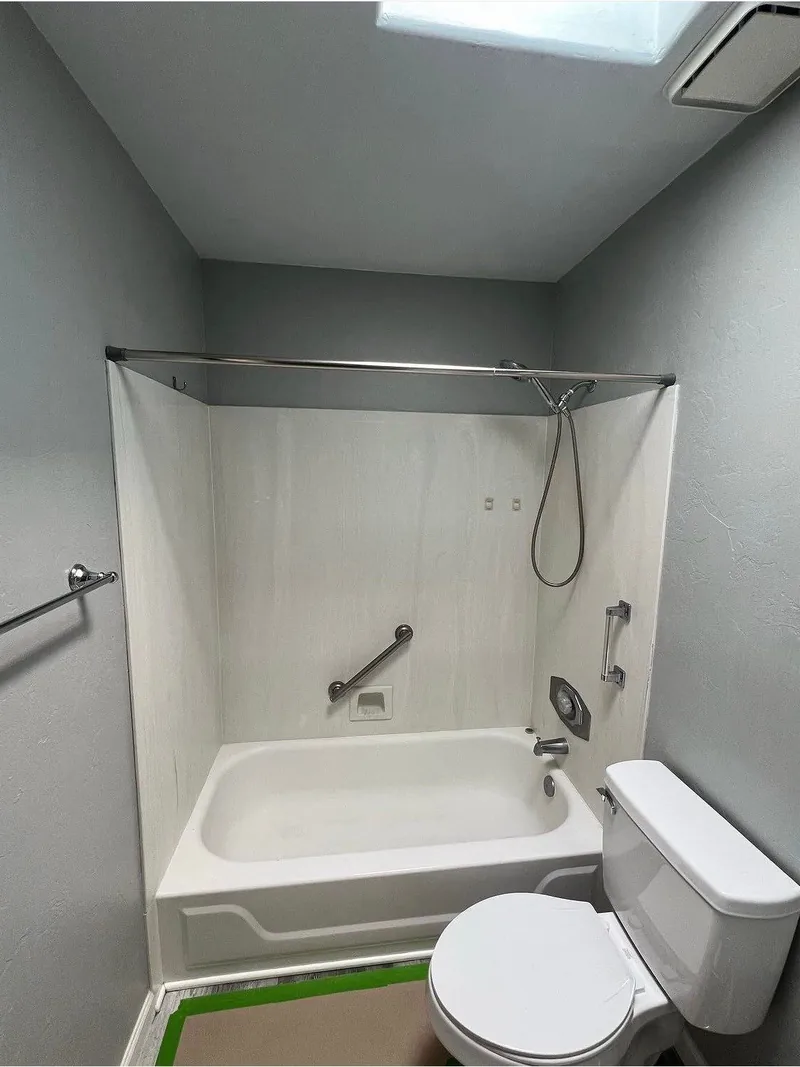 Remodeled bathroom with a tiled tub-and-shower surround