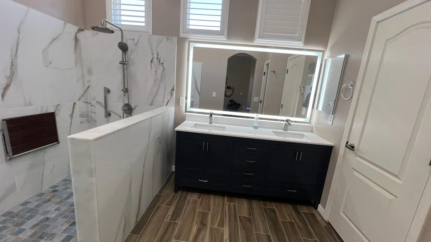 Finished primary-bath remodel with a double vanity, freestanding tub, and glass walk-in shower